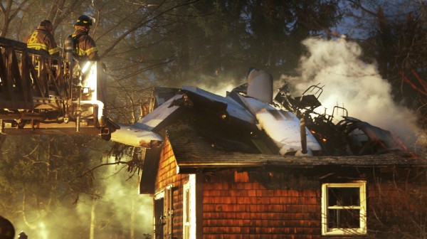 Firemen work at the scene where a small plane crashed into a house near the Biddeford Municipal Airport Sunday evening, April 10, 2011. The Federal Aviation Administration said the pilot of the plane died in the crash. Firemen work at the scene where a small plane crashed into a house near the Biddeford Municipal Airport Sunday evening, April 10, 2011. The Federal Aviation Administration said the pilot of the plane died in the crash.