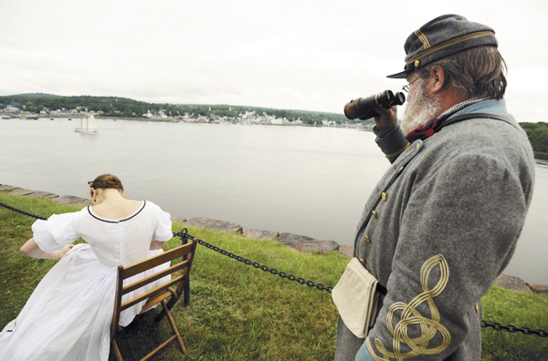 Ed Mann (right) of Aiken, S.C., watches the schooner Bowdoin from Fort Knox in Prospect as Molly Faulkner of Old Saybrook, Conn., works on embroidery. Mann came to the Civil War re-enactment in the summer of 2010 as a spectator but couldn't resist getting suited up as the Confederate soldier he plays when in South Carolina as part of Hardee's Brigade South Guard. Ed Mann (right) of Aiken, S.C., watches the schooner Bowdoin from Fort Knox in Prospect as Molly Faulkner of Old Saybrook, Conn., works on embroidery. Mann came to the Civil War re-enactment in the summer of 2010 as a spectator but couldn't resist getting suited up as the Confederate soldier he plays when in South Carolina as part of Hardee's Brigade South Guard.