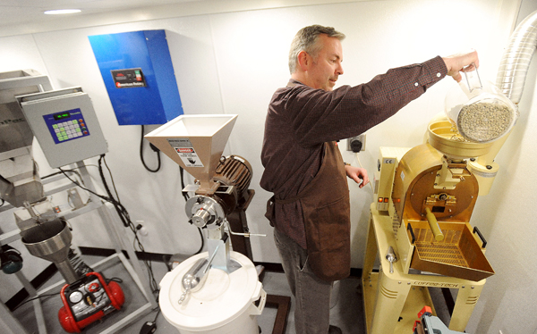 Jeff Savage of the Savage & Sons Gourmet Coffee dumps some raw coffee beans into the roaster at his home in Bangor. Savage started the business in November of last year and currently produces three kinds of fresh roasted coffee. Jeff Savage of the Savage & Sons Gourmet Coffee dumps some raw coffee beans into the roaster at his home in Bangor. Savage started the business in November of last year and currently produces three kinds of fresh roasted coffee.