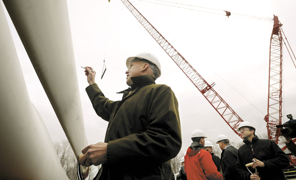 Paul Gaynor, CEO of Massachusetts-based First Wind, signs one of the windmill blades at the Stetson II wind project expansion in Township 8 Range 4 near Danforth. Paul Gaynor, CEO of Massachusetts-based First Wind, signs one of the windmill blades at the Stetson II wind project expansion in Township 8 Range 4 near Danforth.