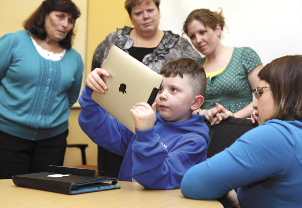 Kindergartener Lucius Rice, 6 (center) demonstrates to Kindergarten teachers (from left) Sue Larue, Kelly McCarthy and Amy Himerl how to uses an iPad as literacy teacher Maurie Dufour (right) looks on Tuesday, in Auburn. The teachers were given iPads to try out in preparation for next year when nearly 300 kindergartners will be given their own iPad2s. Kindergartener Lucius Rice, 6 (center) demonstrates to Kindergarten teachers (from left) Sue Larue, Kelly McCarthy and Amy Himerl how to uses an iPad as literacy teacher Maurie Dufour (right) looks on Tuesday, in Auburn. The teachers were given iPads to try out in preparation for next year when nearly 300 kindergartners will be given their own iPad2s.