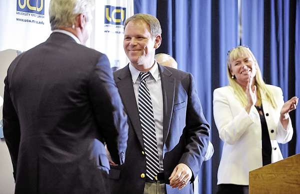 Newly appointed University of Maine women's basketball coach Richard Barron (center) received hearty congratulations from University of Maine Athletic Director Steve Abbott (left) UMaine Hall of Fame basketball player Emily Ellis (right) and others during a press conference introducing him at Memorial Gym in Orono Tuesday.
Newly appointed University of Maine women's basketball coach Richard Barron (center) received hearty congratulations from University of Maine Athletic Director Steve Abbott (left) UMaine Hall of Fame basketball player Emily Ellis (right) and others during a press conference introducing him at Memorial Gym in Orono Tuesday.