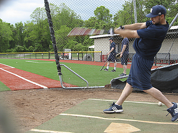 Senior outfielder Joey Martin takes a cut in the batting cage Tuesday during the University of Maine baseball team's workout at Joe Nathan Field on the campus of Stony Brook University in Stony Brook, N.Y. BDN photo by Pete Warner Senior outfielder Joey Martin takes a cut in the batting cage Tuesday during the University of Maine baseball team's workout at Joe Nathan Field on the campus of Stony Brook University in Stony Brook, N.Y. BDN photo by Pete Warner