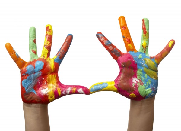 A child’s hands covered in finger paint. A child’s hands covered in finger paint.