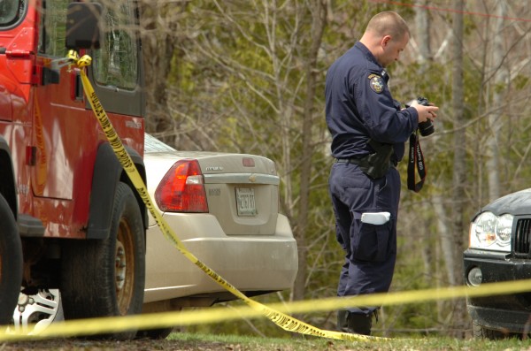 Returning to the scene of a Sunday shooting that left one man dead, Maine State Police detectives confer as they consider evidence around a red ATV on the lawn of 155 French Road in Dover-Foxcroft early Monday. A half dozen investigators were on scene taking photographs, surveying the site and collecting evidence. Returning to the scene of a Sunday shooting that left one man dead, Maine State Police detectives confer as they consider evidence around a red ATV on the lawn of 155 French Road in Dover-Foxcroft early Monday. A half dozen investigators were on scene taking photographs, surveying the site and collecting evidence.