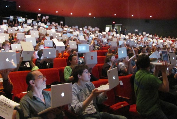 Hundreds of Maine students who gathered Thursday at the University of Maine's Collins Center for the Arts hold up the Apple laptops they use as part of the Maine Learning Technology Initiative. A presenter at the conference said this scene will be sent directly to Apple co-founder Steve Jobs. Hundreds of Maine students who gathered Thursday at the University of Maine's Collins Center for the Arts hold up the Apple laptops they use as part of the Maine Learning Technology Initiative. A presenter at the conference said this scene will be sent directly to Apple co-founder Steve Jobs.
