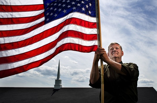Bob Moats, a Pastor at The Christian Bible Fellowship church in Newville, Penn., holds a flag last week. Bob Moats, a Pastor at The Christian Bible Fellowship church in Newville, Penn., holds a flag last week.