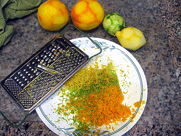 Grating orange, lemon and lime peels with a cheese grater is a way to incorporate citrus flavor into a home-brew. Grating orange, lemon and lime peels with a cheese grater is a way to incorporate citrus flavor into a home-brew.
