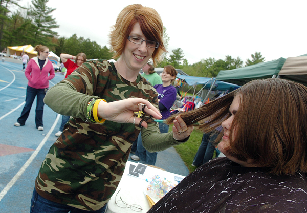 Hairstylist Tracey Nason of Old Town puts the finishing touches on Sarah Frick's new haircut after Frick donated about eight inches of her hair to Pantene's Beautiful Lengths campaign during the 2011 Penobscot Relay for Life on Saturday at Morse Field at the University of Maine in Orono. Beautiful Lengths utilizes the hair to make wigs for women who have lost their hair due to cancer treatment. Saturday was the third time Frick, who is from Eddington, has donated her hair and the second time she has participated in the Penobscot Relay for Life. Hairstylist Tracey Nason of Old Town puts the finishing touches on Sarah Frick's new haircut after Frick donated about eight inches of her hair to Pantene's Beautiful Lengths campaign during the 2011 Penobscot Relay for Life on Saturday at Morse Field at the University of Maine in Orono. Beautiful Lengths utilizes the hair to make wigs for women who have lost their hair due to cancer treatment. Saturday was the third time Frick, who is from Eddington, has donated her hair and the second time she has participated in the Penobscot Relay for Life.
