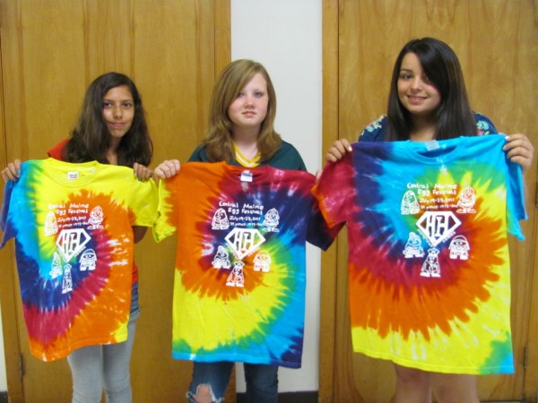 Organizers of the annual Central Maine Egg Festival in Pittsfield turned to local student artists for the design of this year's official Egg Festival T-shirt on the theme of "Hometown Heroes," Warsaw Middle School seventh-grader Jamie Wone of Pittsfield (right) submitted the winning design, which features a fireman, a doctor, a soldier, a policeman and a teacher — all fashioned in the shape of eggs. Sixth-graders Ashley Sumrall of Pittsfield (center), and Emillie Singh (left), also of Pittsfield, placed second and third, respectively. The T-shirts are for sale at the Pitssfield Municipal Building for $18, which benefits festival programming. Organizers of the annual Central Maine Egg Festival in Pittsfield turned to local student artists for the design of this year's official Egg Festival T-shirt on the theme of "Hometown Heroes," Warsaw Middle School seventh-grader Jamie Wone of Pittsfield (right) submitted the winning design, which features a fireman, a doctor, a soldier, a policeman and a teacher — all fashioned in the shape of eggs. Sixth-graders Ashley Sumrall of Pittsfield (center), and Emillie Singh (left), also of Pittsfield, placed second and third, respectively. The T-shirts are for sale at the Pitssfield Municipal Building for $18, which benefits festival programming.