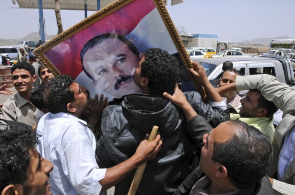 Supporters of Yemeni President Ali Abdullah Saleh kiss his portrait as they celebrate news that Saleh's health is stable, after being taken to Saudi Arabia to receive medical treatment for wounds he suffered in a rocket attack on his compound, in Sanaa, Yemen, Thursday, June 9, 2011. Government troops trying to recapture areas held by Islamic militants have killed 12 suspected al-Qaida members in the troubled southern province of Abyan, the Defense Ministry said Thursday. Supporters of Yemeni President Ali Abdullah Saleh kiss his portrait as they celebrate news that Saleh's health is stable, after being taken to Saudi Arabia to receive medical treatment for wounds he suffered in a rocket attack on his compound, in Sanaa, Yemen, Thursday, June 9, 2011. Government troops trying to recapture areas held by Islamic militants have killed 12 suspected al-Qaida members in the troubled southern province of Abyan, the Defense Ministry said Thursday.