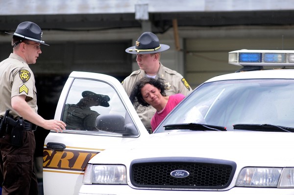 Sgt. William Birch (left) and Chief Deputy Troy Morton, both of the Penobscot County Sheriffs Dept., help Torianne Barrett into a sherriffs car as they prepare to take her for a medical evaluation following a report of a home invasion at the Eddington residence of Barrett and her husband Abram Barrett Thursday morning, June 2, 2011. Sgt. William Birch (left) and Chief Deputy Troy Morton, both of the Penobscot County Sheriffs Dept., help Torianne Barrett into a sherriffs car as they prepare to take her for a medical evaluation following a report of a home invasion at the Eddington residence of Barrett and her husband Abram Barrett Thursday morning, June 2, 2011.