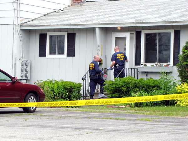State Police investigators enter the Farmington home of Grace Burton at 195 Fairbanks Road, Apt. 5, Tuesday. Burton, 81, was killed during a home invasion early Tuesday morning, June 21, 2011. State Police investigators enter the Farmington home of Grace Burton at 195 Fairbanks Road, Apt. 5, Tuesday. Burton, 81, was killed during a home invasion early Tuesday morning, June 21, 2011.