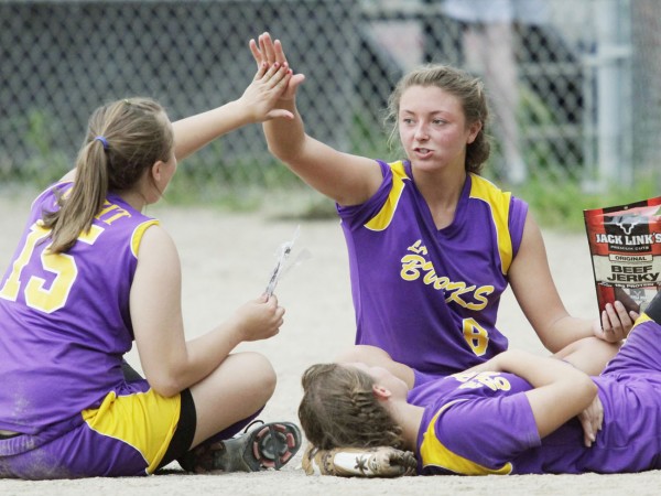 Bucksport's Abby Yeo (right) and Debbie Wight give a high-five as teammate Mindy Pye relaxes on the ground in front of their dugout during a lightning delay in the fifth inning of their Eastern Maine Class B quarterfinal against Mattanawcook Academy Thursday in Bucksport. The Golden Bucks defeated the Lynx of Lincoln 7-2.
Bucksport's Abby Yeo (right) and Debbie Wight give a high-five as teammate Mindy Pye relaxes on the ground in front of their dugout during a lightning delay in the fifth inning of their Eastern Maine Class B quarterfinal against Mattanawcook Academy Thursday in Bucksport. The Golden Bucks defeated the Lynx of Lincoln 7-2.