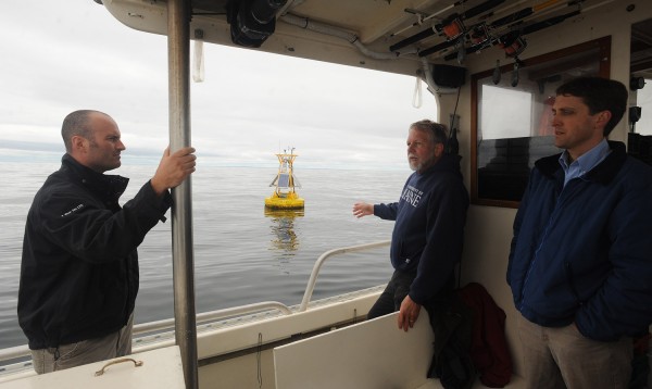 Peter Jumars, the director of School of Marine Sciences at the University of Maine, talks about an observation buoy at the future site of an offshore wind energy test turbine about two miles south of Monhegan Island during a tour of the area Monday. On the left is Dr. Christopher Hart of the U.S. Department of Energy on the right is Peter Browne of HDR Enigineering. Peter Jumars, the director of School of Marine Sciences at the University of Maine, talks about an observation buoy at the future site of an offshore wind energy test turbine about two miles south of Monhegan Island during a tour of the area Monday. On the left is Dr. Christopher Hart of the U.S. Department of Energy on the right is Peter Browne of HDR Enigineering.
