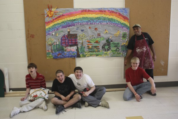 Russell Kahn’s adaptive art class at Camden Hills Regional High School has something to smile about. The class interpreted one of Eric Carle’s painting-collages from “Draw Me a Star.” The big difference was that the students used construction paper and tempera paint instead of tissue paper and acrylics. But the process was the same. The class spent time creating an inventory of colored paper with a variety of texture and mark-making using brushes, sponges, forks, etc. They cut from the painted paper and regular construction paper and glued the shapes down. The adaptive art class was implemented a few years ago by Kahn for students who may need more one-to-one guidance with their art. In the final picture are (from left) Wyatt Timchak, Garrett Robbins, Christopher Cole, Kobi Kangas and Kahn. Russell Kahn’s adaptive art class at Camden Hills Regional High School has something to smile about. The class interpreted one of Eric Carle’s painting-collages from “Draw Me a Star.” The big difference was that the students used construction paper and tempera paint instead of tissue paper and acrylics. But the process was the same. The class spent time creating an inventory of colored paper with a variety of texture and mark-making using brushes, sponges, forks, etc. They cut from the painted paper and regular construction paper and glued the shapes down. The adaptive art class was implemented a few years ago by Kahn for students who may need more one-to-one guidance with their art. In the final picture are (from left) Wyatt Timchak, Garrett Robbins, Christopher Cole, Kobi Kangas and Kahn.