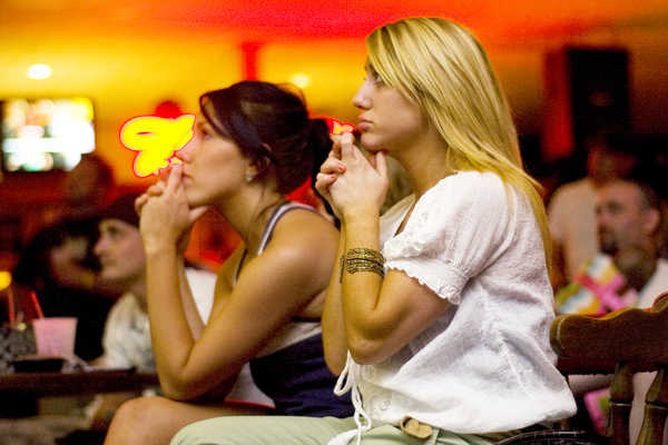 Sasha Roy (right) and Bridgitte Goulet, both of Lewiston, clasp their hands in nervous anticipation at Club Texas in Auburn on Monday night while watching the finale of the professional wrestling reality show "Tough Enough," which featured their friend and Auburn resident Luke Robinson. Robinson lost the show in the final round, missing a chance for a WWE contract and professional wrestling superstardom. Sasha Roy (right) and Bridgitte Goulet, both of Lewiston, clasp their hands in nervous anticipation at Club Texas in Auburn on Monday night while watching the finale of the professional wrestling reality show "Tough Enough," which featured their friend and Auburn resident Luke Robinson. Robinson lost the show in the final round, missing a chance for a WWE contract and professional wrestling superstardom.