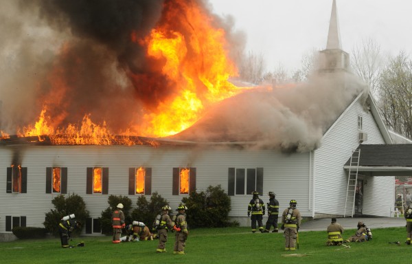 Firefighters from numerous departments pull back as the roof collapses on the Calvary Apostolic Church in Winterport last month. The church says it will be used again and is in the beginning stages of making rebuilding plans. Rev. Tom Channell of the church says they are planning on building a family life center. Firefighters from numerous departments pull back as the roof collapses on the Calvary Apostolic Church in Winterport last month. The church says it will be used again and is in the beginning stages of making rebuilding plans. Rev. Tom Channell of the church says they are planning on building a family life center.