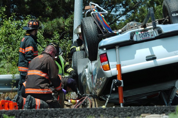 Brewer rescue personnel check on the victim in a rolled-over pickup truck in a Tuesday morning accident on the I-395 off-ramp to South Main Street in Brewer. Brewer rescue personnel check on the victim in a rolled-over pickup truck in a Tuesday morning accident on the I-395 off-ramp to South Main Street in Brewer.