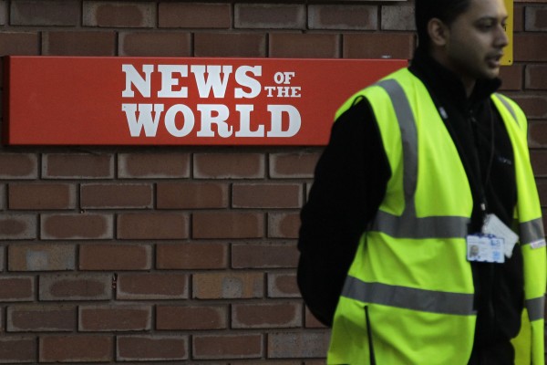 A security officer stands at the gates outside the publisher of News of the World, News International's headquarters in London, Thursday, July 7, 2011. Sunday newspaper News of the World is accused of hacking into the mobile phones of crime victims, celebrities and politicians, prompting News International to announce Thursday that the papers is to cease publication after publication upcoming Sunday. A security officer stands at the gates outside the publisher of News of the World, News International's headquarters in London, Thursday, July 7, 2011. Sunday newspaper News of the World is accused of hacking into the mobile phones of crime victims, celebrities and politicians, prompting News International to announce Thursday that the papers is to cease publication after publication upcoming Sunday.