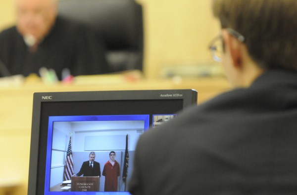 A video screen displays Danny Adams, right of Pittsfield and his attorney Aaron Frey during Adams' video appearance before Superior Court Justice Kirk Studstrup (seen in background) at Penobscot Judicial Center in Bangor Wednesday afternoon, July 13, 2011. In the foreground is legal intern Hunter Umphrey, right, who worked with Assistant District Attorney Jim Aucoin during the proceeding. A video screen displays Danny Adams, right of Pittsfield and his attorney Aaron Frey during Adams' video appearance before Superior Court Justice Kirk Studstrup (seen in background) at Penobscot Judicial Center in Bangor Wednesday afternoon, July 13, 2011. In the foreground is legal intern Hunter Umphrey, right, who worked with Assistant District Attorney Jim Aucoin during the proceeding.