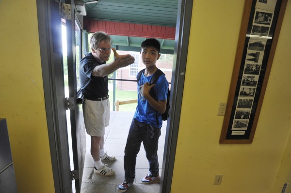 Lee Academy headmaster Bruce Lindberg (left) directs a student who referred to himself as "James" into the school cafeteria for brunch during his first day in Lee Friday, July 8. Lee Academy headmaster Bruce Lindberg (left) directs a student who referred to himself as "James" into the school cafeteria for brunch during his first day in Lee Friday, July 8.