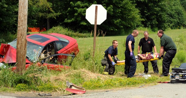 First responders put Micah Bouchard, 32, of Bangor on a gurney after he was taken out of his damaged vehicle. First responders put Micah Bouchard, 32, of Bangor on a gurney after he was taken out of his damaged vehicle.