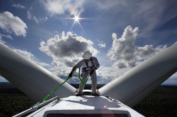 Mike Cianchette, operations manager of the Stetson Mountain wind project, checks his safety line before making inspections on top of a 300-foot tall windmill, in Township 8, Range 3, in July. Mike Cianchette, operations manager of the Stetson Mountain wind project, checks his safety line before making inspections on top of a 300-foot tall windmill, in Township 8, Range 3, in July.