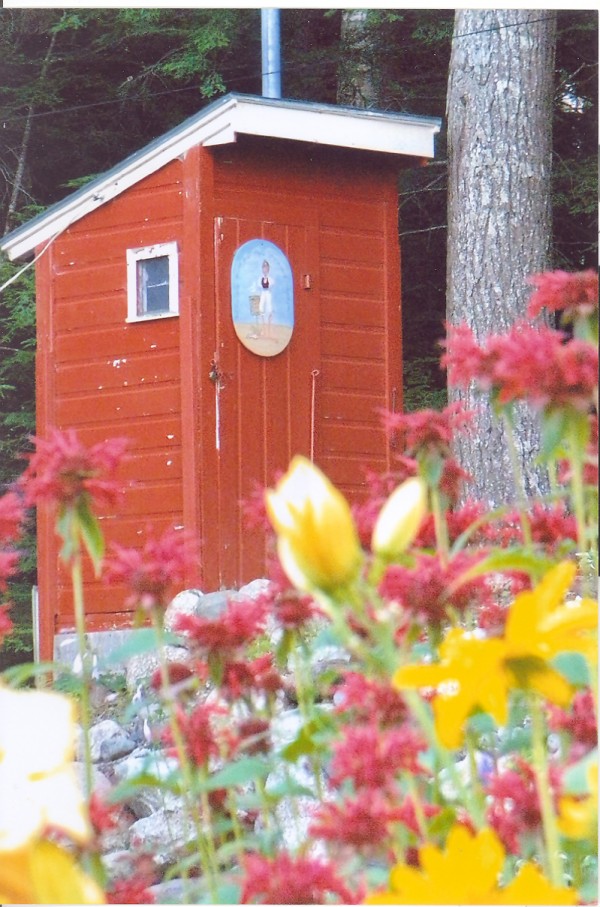 I am an outhouse located at Beech Hill Pond. I have had three owners over the years. I was born in 1950 on the West Shore Road and have had many good years. There are many attributes that make me a unique outhouse. I am able to host two users at the same time, I have electricity, I am painted and decorated, and now I have a new tiled floor. But I have not always been so impressive.
During my life with my second owner, I began to deteriorate. I need a new skirt, new paint, roof work, and most of all a new floor. On the 4th of July celebrations of 2000, I was hosting two users. When they were doing their thing, my floor gave way and the larger of the two woman dropped six feet to the bottom of the outhouse. It required a ladder to get her out.
Needless to say, the lady never returned to visit me and shortly after this traumatic event the camp was sold to the current owners. They have turned me around and given me a second life. I now have new paint inside and out, a new skirt, better lighting and most importantly a new floor to host my guests.
With my second chance of life I feel I am one of the best outhouses out there. I have many friends on Beech Hill Pond, and I am by far the most attractive outhouse of them all.