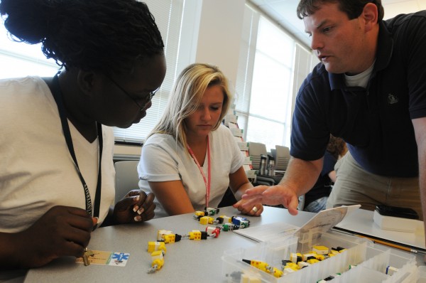 Viola Ogak (from left) of Catherine McAuley High School and Taylor Porter of Camden Hills Regional High School get help from Husson University second-year student Jonathan Anderson during the Pharmacy Camp at Husson University on Wednesday, July 20, 2011. The students used custom Lego blocks to build DNA molecules and learned how the molecules changed as food is digested. Viola Ogak (from left) of Catherine McAuley High School and Taylor Porter of Camden Hills Regional High School get help from Husson University second-year student Jonathan Anderson during the Pharmacy Camp at Husson University on Wednesday, July 20, 2011. The students used custom Lego blocks to build DNA molecules and learned how the molecules changed as food is digested.
