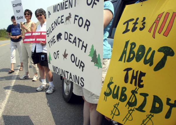 Protesters stand on Route 6 outside First Wind's $130 million industrial wind site on Wednesday, July 20, 2011, saying the project was a blight on Rollins Mountain and would lead to declining land values in the project's four towns. Protesters stand on Route 6 outside First Wind's $130 million industrial wind site on Wednesday, July 20, 2011, saying the project was a blight on Rollins Mountain and would lead to declining land values in the project's four towns.