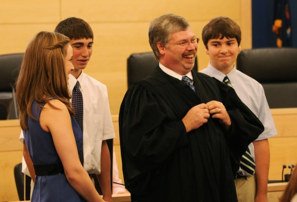 Surrounded by his children, Katie (from left) Billy and Gregory, new district court judge Greg Campbell grins as he faces a packed court room after his children helped him into a robe for the first time on Friday, July 1, 2011 at the Penobscot Judicial Center in Bangor. Surrounded by his children, Katie (from left) Billy and Gregory, new district court judge Greg Campbell grins as he faces a packed court room after his children helped him into a robe for the first time on Friday, July 1, 2011 at the Penobscot Judicial Center in Bangor.