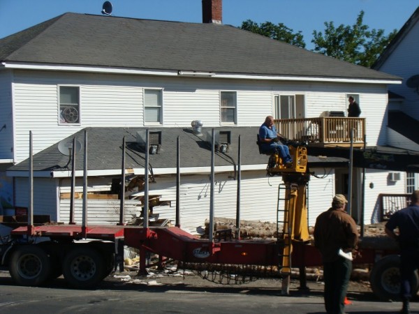 Workers remove logs that spilled early Tuesday, Aug. 23, 2011, when the driver of a tractor-trailer truck lost control of his vehicle while rounding a curve in Cambridge. Workers remove logs that spilled early Tuesday, Aug. 23, 2011, when the driver of a tractor-trailer truck lost control of his vehicle while rounding a curve in Cambridge.