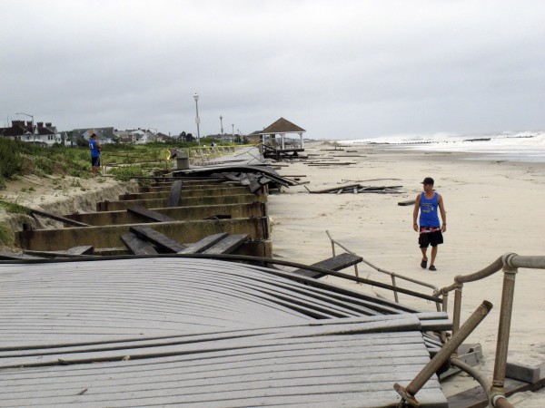 Spectators look at the ruined boardwalk in Spring lake, N.J., on Sunday Aug. 28, 2011, hours after Hurricane Irene damaged 1.5 miles of the 2-mile walkway. Tourist-dependent towns are rushing to repair damage in time for Labor Day weekend, hoping tourists don't simply give up on summer. Spectators look at the ruined boardwalk in Spring lake, N.J., on Sunday Aug. 28, 2011, hours after Hurricane Irene damaged 1.5 miles of the 2-mile walkway. Tourist-dependent towns are rushing to repair damage in time for Labor Day weekend, hoping tourists don't simply give up on summer.