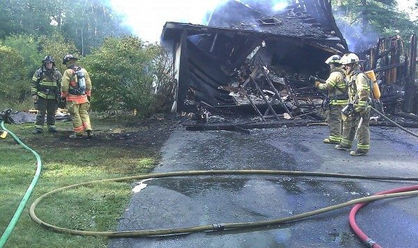 A garage and attached apartment were destroyed Monday afternoon in a fire at a home in Lamoine. According to firefighters, the homeowner had finished mowing his lawn and driven the riding mower into the garage when it backfired. A garage and attached apartment were destroyed Monday afternoon in a fire at a home in Lamoine. According to firefighters, the homeowner had finished mowing his lawn and driven the riding mower into the garage when it backfired.
