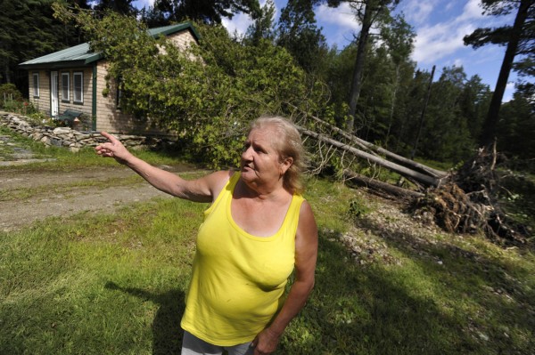 Dale Nickerson walks around her tree-damaged home Monday morning while recounting how Tropical Storm Irene's winds ripped thropugh her neighborhood on Davis Pond in Holden. A cedar tee fell on her roof and a poplar tree fell on her back deck around 7:30 p.m Sunday evening, she said. On Monday she decided to wait for the insurance claims adjuster to arrive before having the trees removed. "I made it through last night. I can make it through anything," said Nickerson. Dale Nickerson walks around her tree-damaged home Monday morning while recounting how Tropical Storm Irene's winds ripped thropugh her neighborhood on Davis Pond in Holden. A cedar tee fell on her roof and a poplar tree fell on her back deck around 7:30 p.m Sunday evening, she said. On Monday she decided to wait for the insurance claims adjuster to arrive before having the trees removed. "I made it through last night. I can make it through anything," said Nickerson.