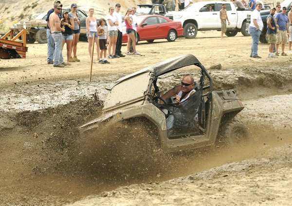 Glen Pomerleau of Poland navigates the mud pit on his all-terrain vehicle at the first annual Redneck Olympics in Hebron on Saturday. Glen Pomerleau of Poland navigates the mud pit on his all-terrain vehicle at the first annual Redneck Olympics in Hebron on Saturday.