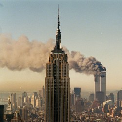 The twin towers of the World Trade Center burn behind the Empire State Building in New York on Sept. 11, 2001.