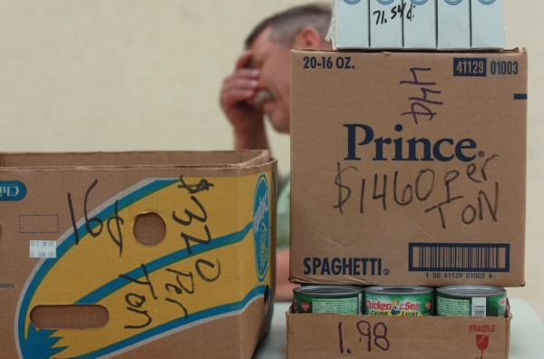 Pastor Tom Bruce of the Living Word Ecumenical Food Cupboard in Dover-Foxcroft sits behind food boxes marked with the price per ton costs many local food banks currently have to pay to feed the hungry during a meeting held at Jeff's Catering in Brewer on Monday, August 8, 2011. Pastor Tom Bruce of the Living Word Ecumenical Food Cupboard in Dover-Foxcroft sits behind food boxes marked with the price per ton costs many local food banks currently have to pay to feed the hungry during a meeting held at Jeff's Catering in Brewer on Monday, August 8, 2011.