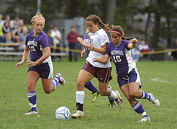 Bangor High School's Ashley Robinson drives toward the goal between Waterville's Lauren Massey (right) and Melanie Bureau to score Bangor's first goal during the first half of the game Tuesday evening. Bangor won 8-0. Bangor High School's Ashley Robinson drives toward the goal between Waterville's Lauren Massey (right) and Melanie Bureau to score Bangor's first goal during the first half of the game Tuesday evening. Bangor won 8-0.
