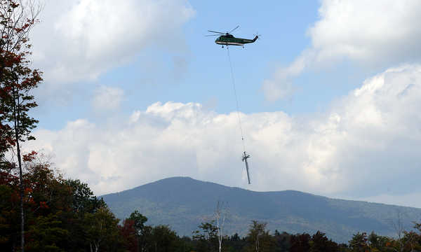 Pilot Stefan Hiltbrunner of Construction Helicopters of Howell, Mich.,lifts one of the Skyline Quad chairlift towers from a parking lot at Sugarloaf Mountain on Wednesday morning. Pilot Stefan Hiltbrunner of Construction Helicopters of Howell, Mich.,lifts one of the Skyline Quad chairlift towers from a parking lot at Sugarloaf Mountain on Wednesday morning.