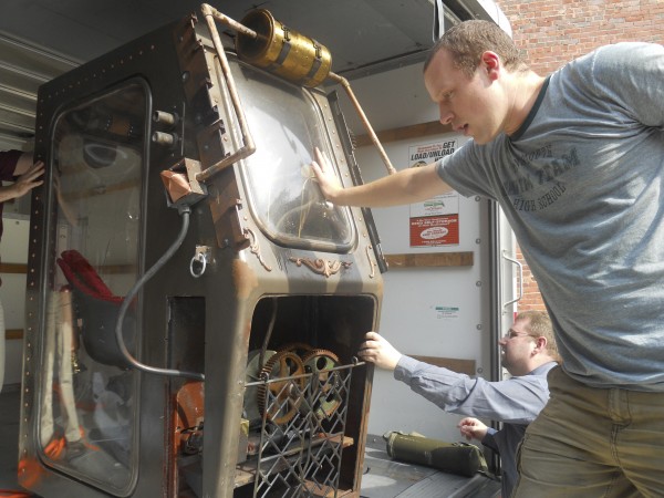 Brunswick artist and filmmaker Christian Matzke (foreground) is helped by Jeff Taylor in moving his interactive "drop pod" sculpture from a U-Haul truck Thursday to nearby Sanctuary Tattoo in Portland, where Matzke's Steam Punk-style artwork is being set up as a faux historical exhibit imagining a human retaliation on Mars in the aftermath of the classic "War of the Worlds" novel. Brunswick artist and filmmaker Christian Matzke (foreground) is helped by Jeff Taylor in moving his interactive "drop pod" sculpture from a U-Haul truck Thursday to nearby Sanctuary Tattoo in Portland, where Matzke's Steam Punk-style artwork is being set up as a faux historical exhibit imagining a human retaliation on Mars in the aftermath of the classic "War of the Worlds" novel.