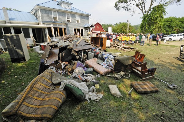 Volunteers take a break to hear from officials at the Perley Farm in Royalton, Vt., Sunday, Sept. 4, 2011. The farm was devastated by floodwaters from the White River during Tropical Storm Irene last week. Volunteers take a break to hear from officials at the Perley Farm in Royalton, Vt., Sunday, Sept. 4, 2011. The farm was devastated by floodwaters from the White River during Tropical Storm Irene last week.