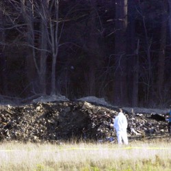 Emergency workers look at the crater created when United Airlines Flight 93 crashed near Shanksville, Pa., on Tuesday, Sept. 11, 2001.