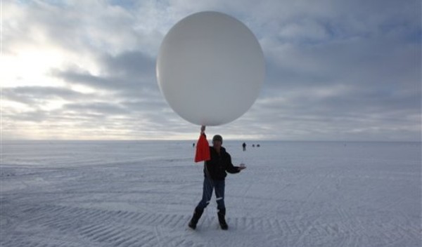 Atop roughly two miles of ice, technician Marie McLane launches a data-transmitting weather balloon at Summit Station, a remote research site. Atop roughly two miles of ice, technician Marie McLane launches a data-transmitting weather balloon at Summit Station, a remote research site.