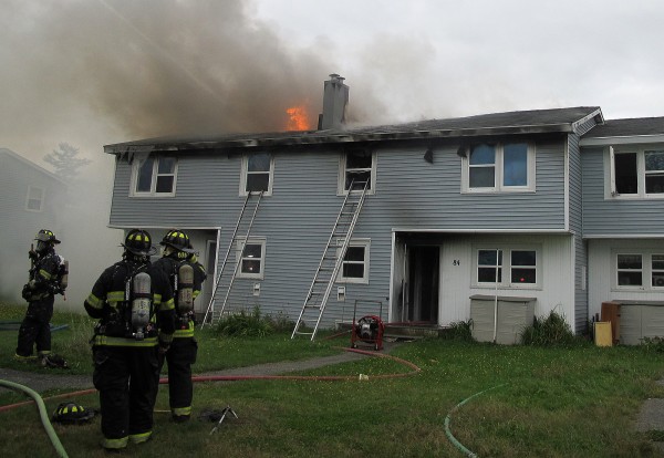 Smoke and flames erupt from the rooftop of an apartment complex on Moosehead Boulevard in Bangor on Tuesday morning. Smoke and flames erupt from the rooftop of an apartment complex on Moosehead Boulevard in Bangor on Tuesday morning.