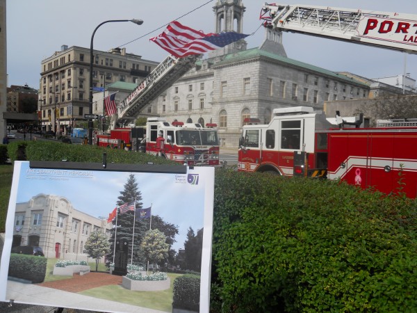 An architect's rendering of a memorial to Portland firefighters who died in the line of duty stands in front of two ladder trucks hoisting the American flag Friday at the memorial's groundbreaking. An architect's rendering of a memorial to Portland firefighters who died in the line of duty stands in front of two ladder trucks hoisting the American flag Friday at the memorial's groundbreaking.