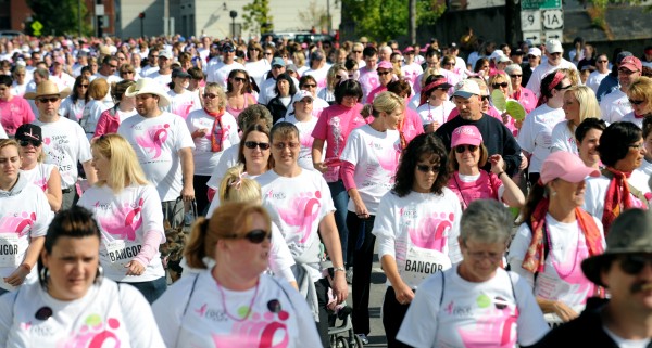 People walk down Main Street in Bangor during the 15th annual Susan G. Komen Race for the Cure in Bangor Sunday morning. More than 5,000 people participated in the event that raises money for breast cancer research. People walk down Main Street in Bangor during the 15th annual Susan G. Komen Race for the Cure in Bangor Sunday morning. More than 5,000 people participated in the event that raises money for breast cancer research.