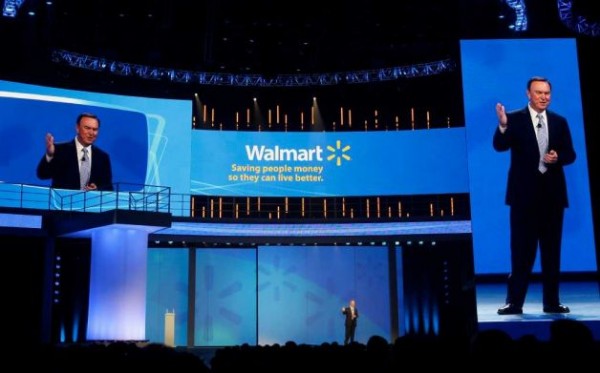 Mike Duke, president and CEO of Wal-Mart, speaks to shareholders as his image appears on screens left and right in Fayetteville, Ark., last spring. Wal-Mart is investing in new technologies to expand shopping. Mike Duke, president and CEO of Wal-Mart, speaks to shareholders as his image appears on screens left and right in Fayetteville, Ark., last spring. Wal-Mart is investing in new technologies to expand shopping.