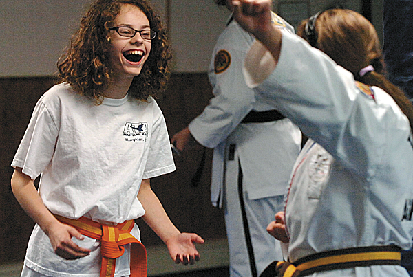 Didi Bryant laughs as she practices at Hampden ATA Martial Arts recently. Owned by Marjorie Earl and featuring an all-female staff, the school attracts many members of both sexes interested in a family- and community-based setup.
Didi Bryant laughs as she practices at Hampden ATA Martial Arts recently. Owned by Marjorie Earl and featuring an all-female staff, the school attracts many members of both sexes interested in a family- and community-based setup.